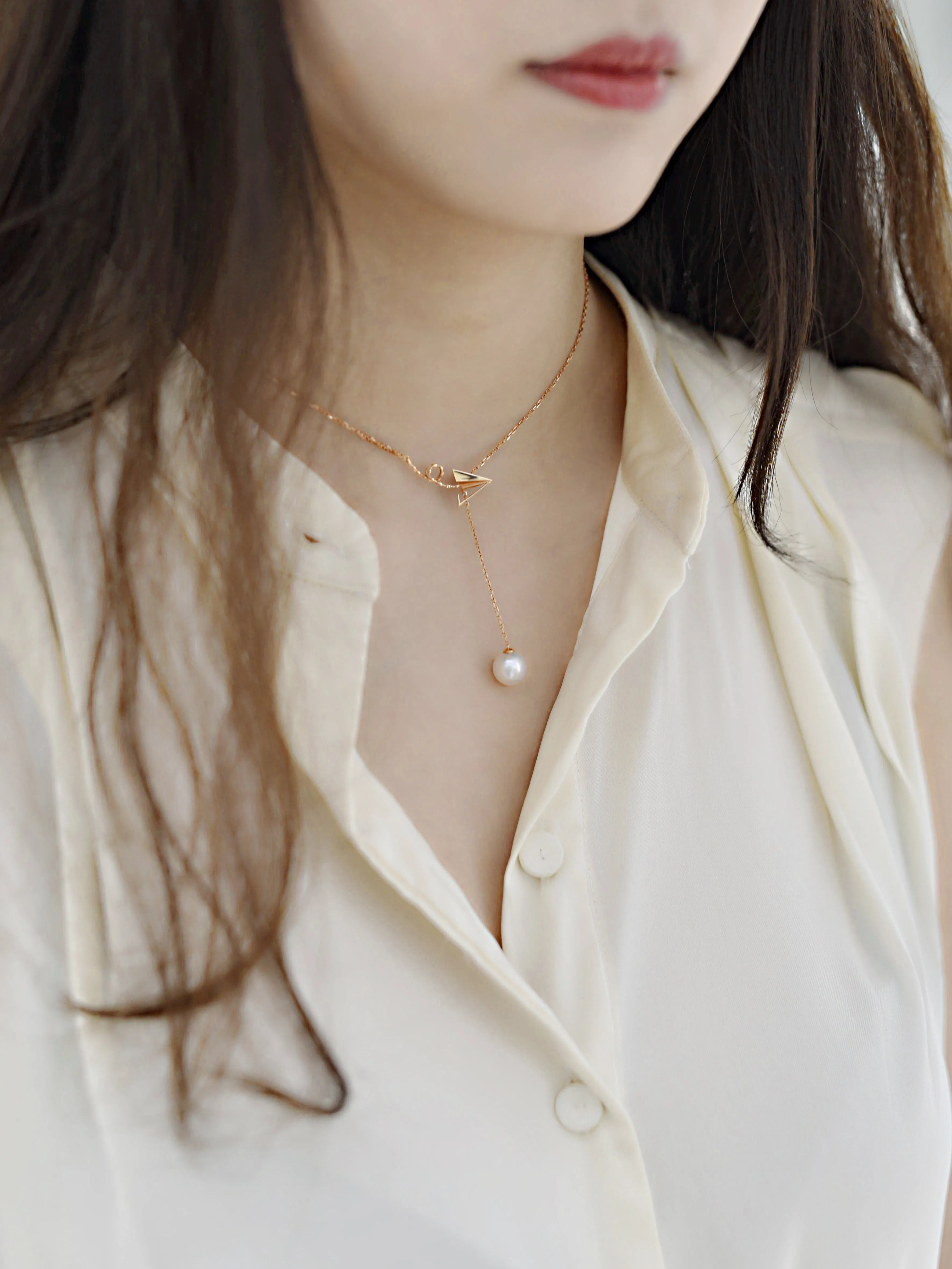 “Origaminx Airplane” 18K gold and Akoya pearl, origami-shaped necklace