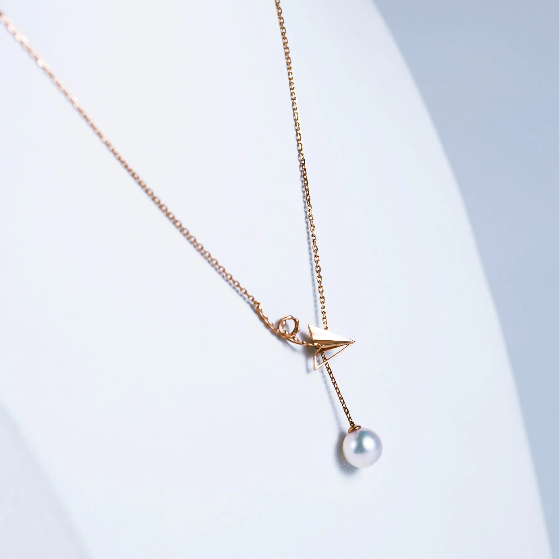 “Origaminx Airplane” 18K gold and Akoya pearl, origami-shaped necklace